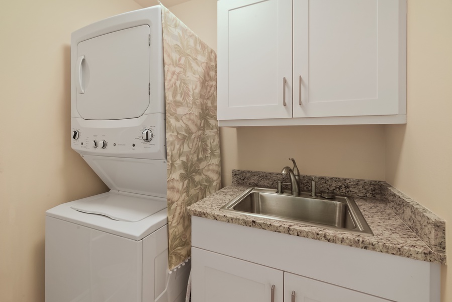 Vacay complete with our dedicated laundry area, equipped with a washer/dryer, sink with cabinets for extra storage, designed for your convenience.