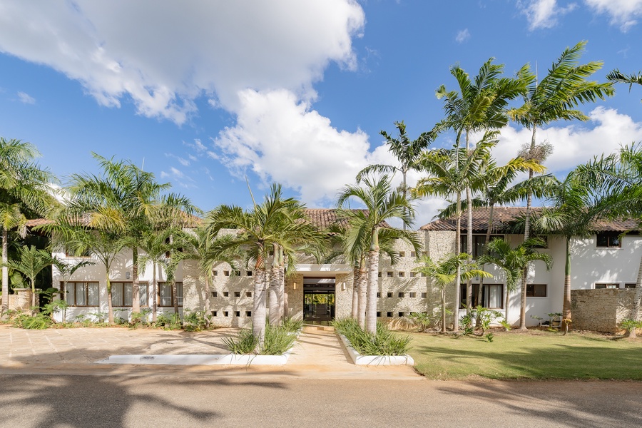 Stunning entrance surrounded by lush palm trees, welcoming you to your tropical getaway at Casa de Campo.