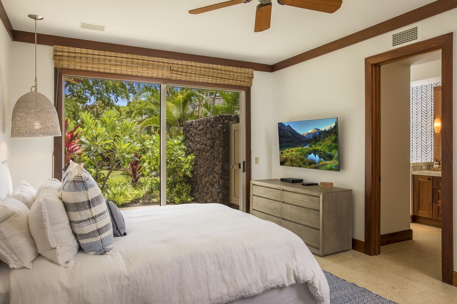 Reverse view featuring private lanai & wall-mounted television