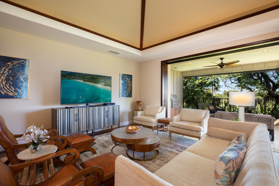 Here, a spacious living area with a sprawling TV set, plush sofas, and an open access to the lanai  invites you to unwind and feel right at home.
