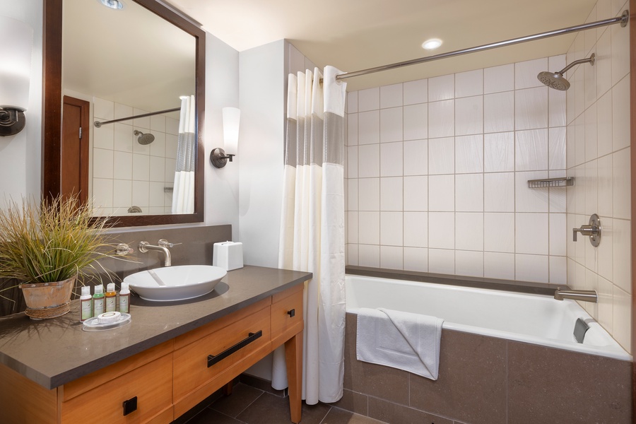 The second guest bathroom has a shower- tub combo.