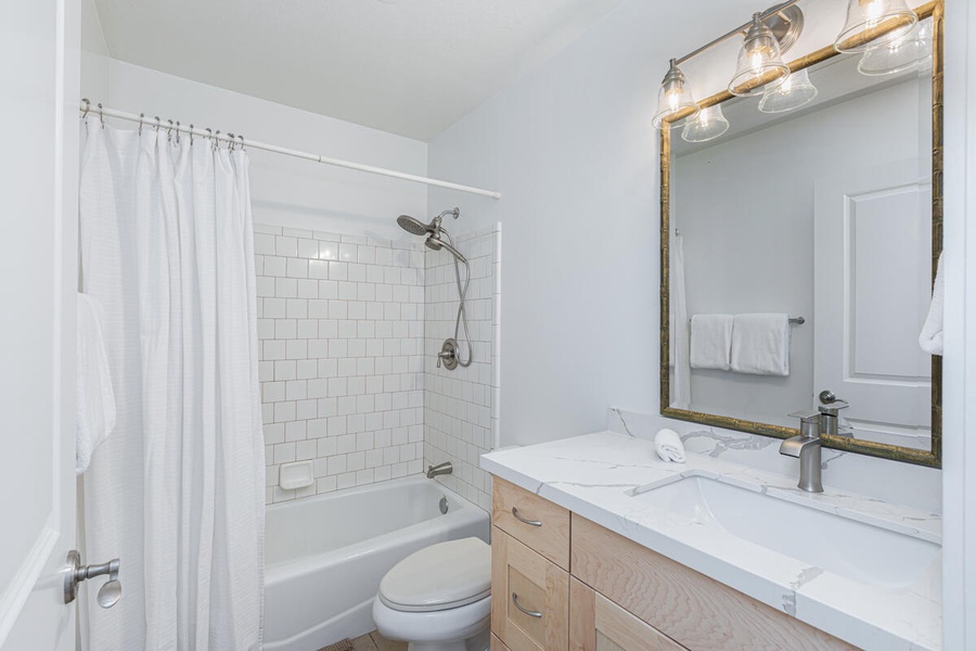 Bright bathroom with a shower and plenty of natural light.