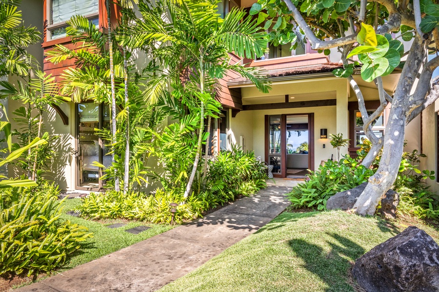 Lush tropical landscaping leads you to your home in paradise.