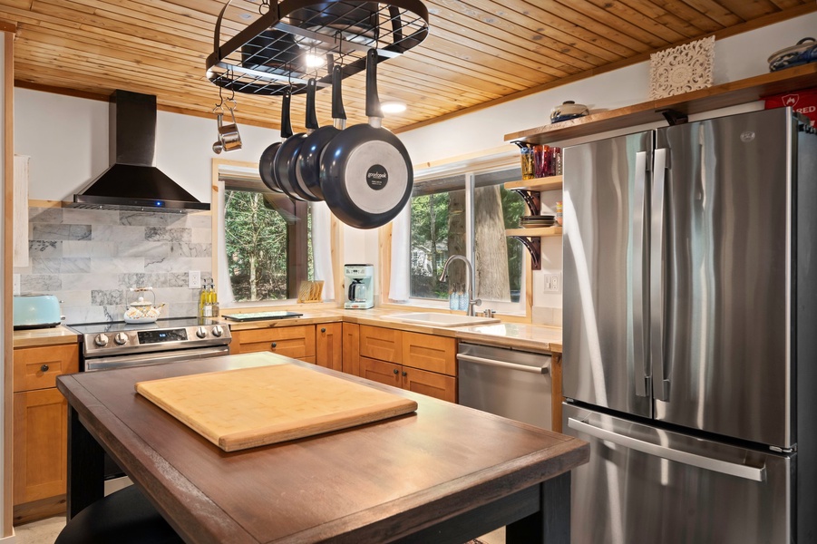 The fully equipped kitchen offers stainless steel appliances, butcher block counters, and all the tools you need for home-cooked meals.