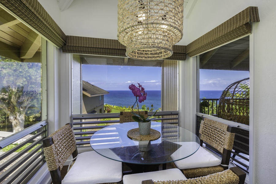 The dining room, with table for four, surrounded by windows, allows you to take full advantage of the ocean view beyond.