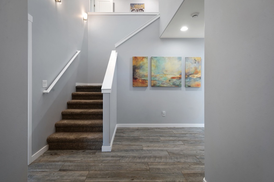 Your welcoming entryway, the staircase leads to your private upper-level retreat.