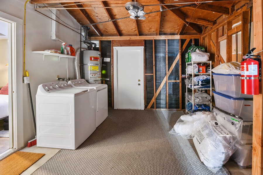 The shared laundry area with washer and dryer located in the garage between studio and house.