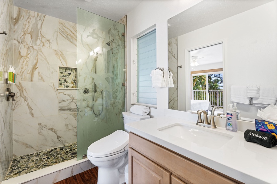 Step into your luxurious bathroom featuring elegant marble tiles, spacious walk-in shower, and pristine amenities for your comfort.