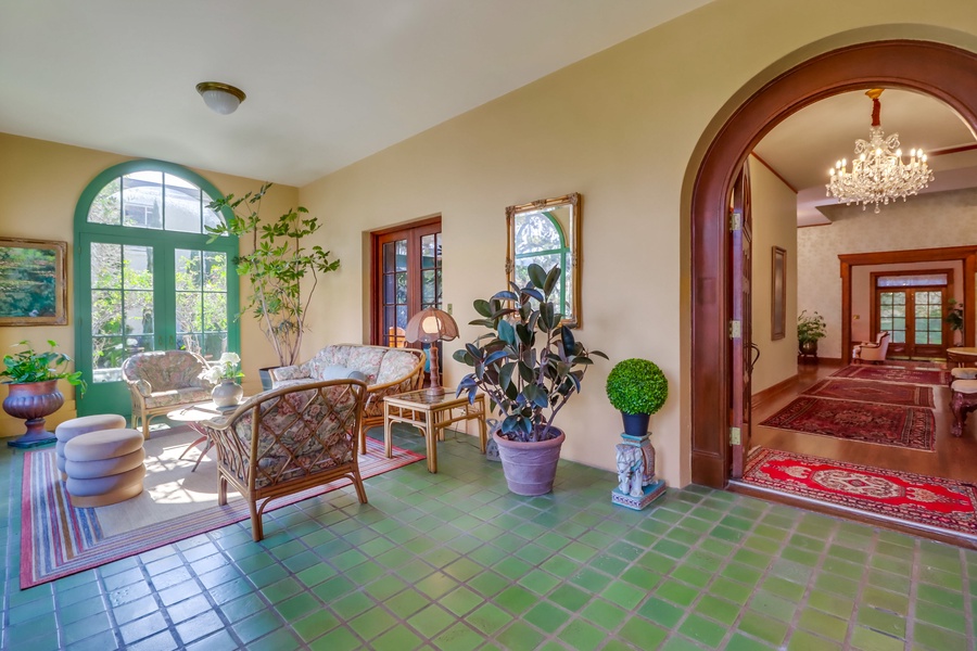 Enter the home through the sunroom, a second living area providing a bright and airy space to relax and unwind.