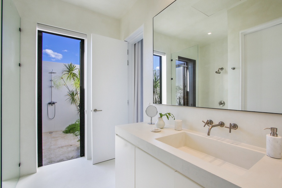 Freshen up in the bright bathroom with easy access to the outdoor shower.