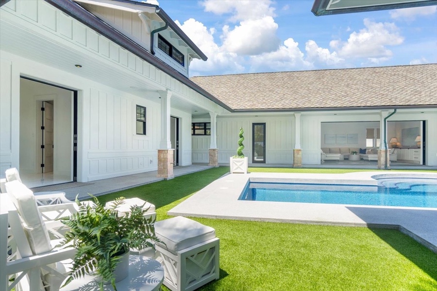 Courtyard-style design surrounding the pool creates seamless indoor-outdoor living.