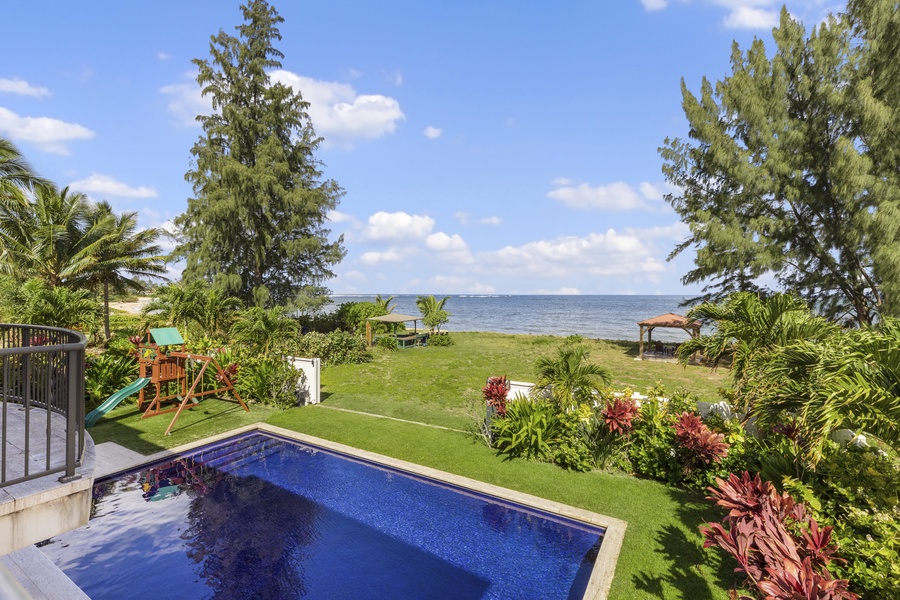 Gates open to a larger yard with a gazebo for enjoying the beach in shade