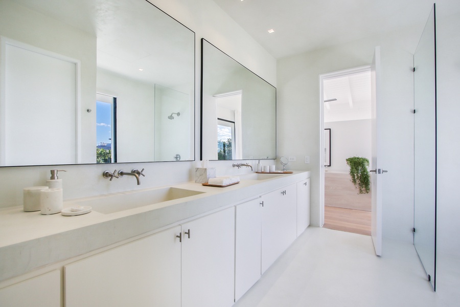 Refresh in the bright ensuite bathroom with double sinks and large mirrors.