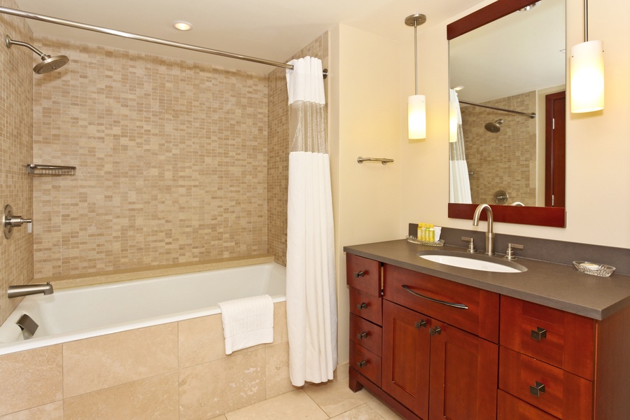The third guest bath has a shower- tub combo.