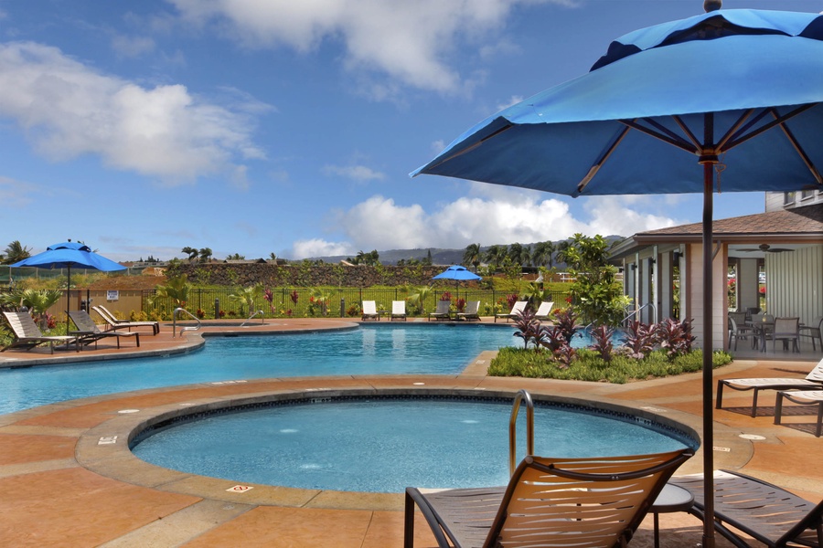 Relax and refresh in the community pool and hot tub, surrounded by lush tropical landscaping.
