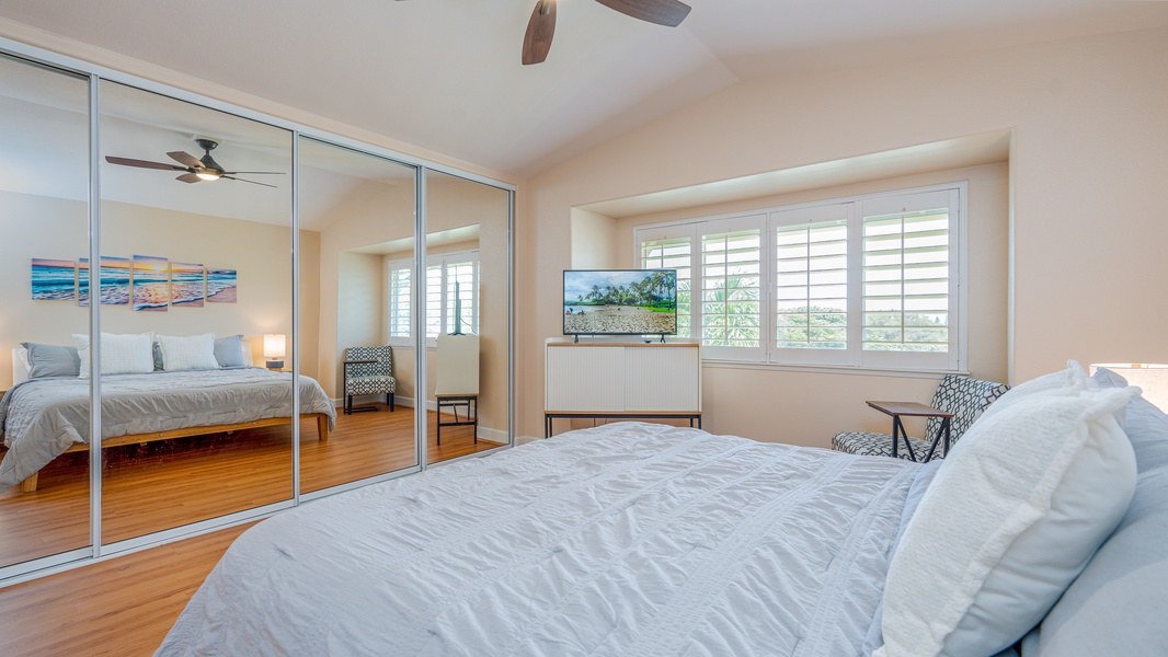 The primary guest bedroom with a television and island scenery.