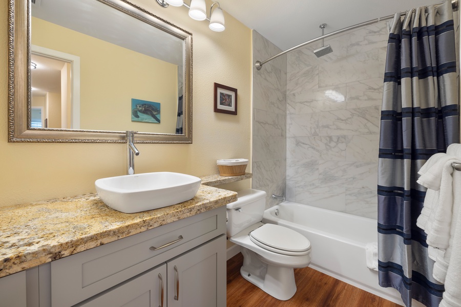 The second bathroom includes a shower-tub combo and ample counter space.