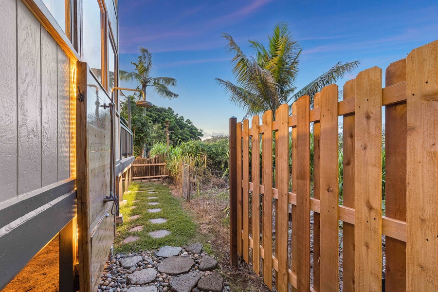 A private path lined with tropical landscaping leads you from garden to gate with ease and charm.