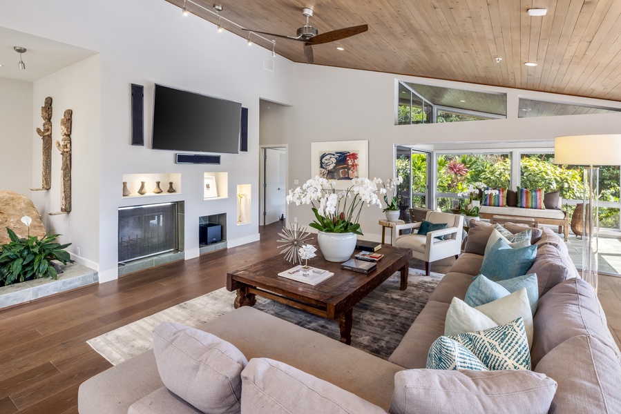 Cozy up in the main living room with designer furnishings and a peaceful garden backdrop.