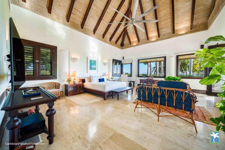 Unwind in the spacious primary bedroom, featuring comfortable furnishings and stunning views.