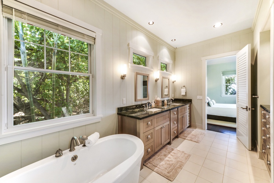 Primary Bath with Luxurious Soaking Tub, Separate and Spacious Tiled Shower w/ Double Shower Heads, Skylight & Tiled Bench, Granite Countertops, Double Sink Vanity and Separate Water Closet.