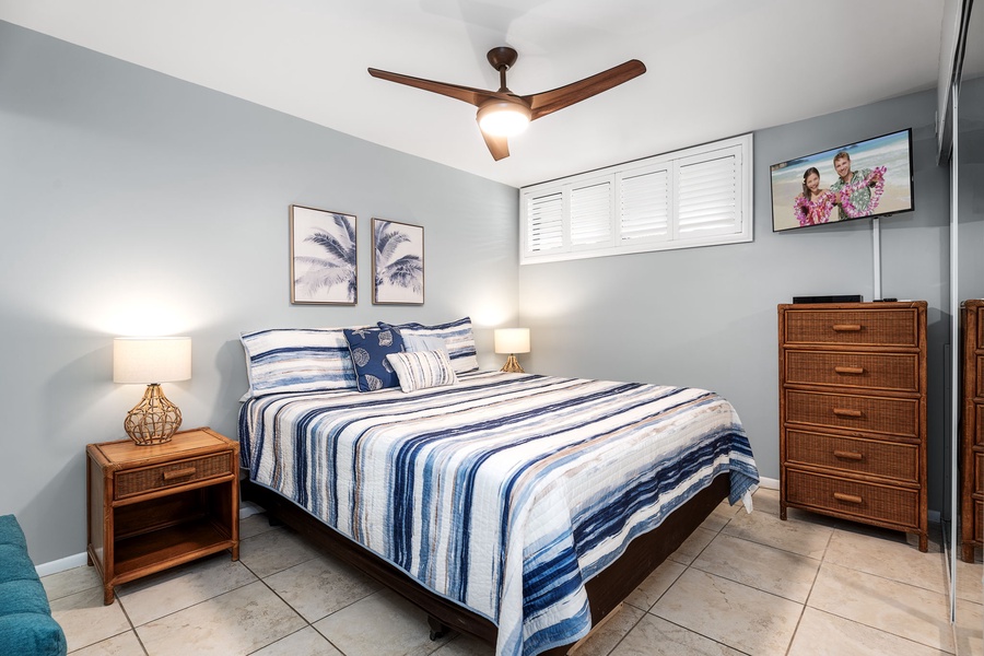 Primary bedroom with king bed, A/C, and ceiling fan—your private, cool retreat after a day in the sun.