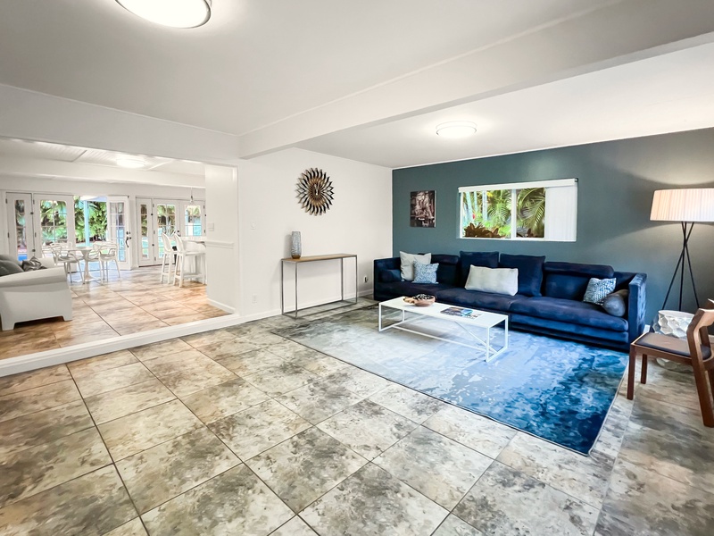 Cozy formal living room with natural light and plush seating.