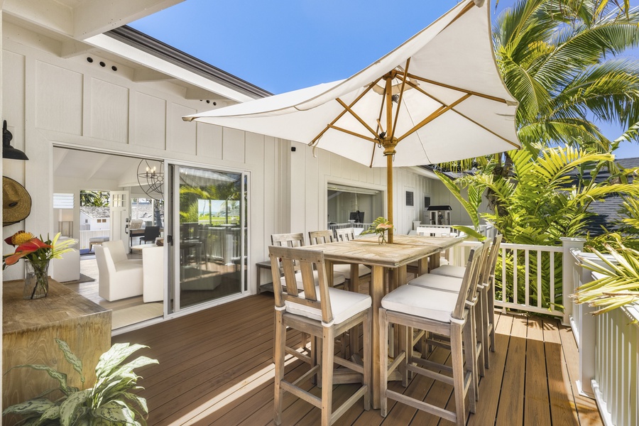 Spacious front house deck featuring a bar-height table, perfect for gatherings of eight.