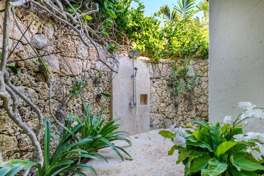 Freshen up in the shower with lush greenery.