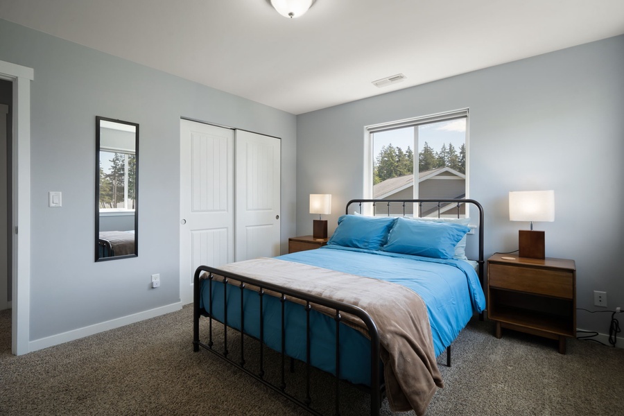 This comfortable bedroom offers plush queen bed, simple modern décor, and a relaxing atmosphere throughout your stay.