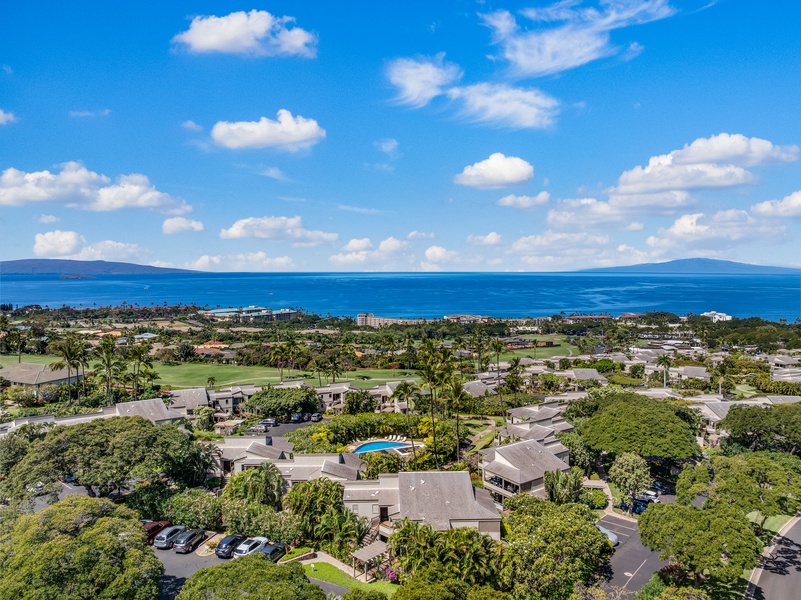Aerial view of Wailea Ekolu 1106 grounds, surrounded by palms, ocean views, and open skies.