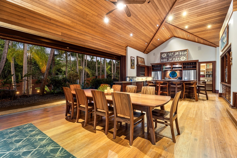 Gather around this stunning dining space where warm wood meets tropical views, perfect for memorable meals together.