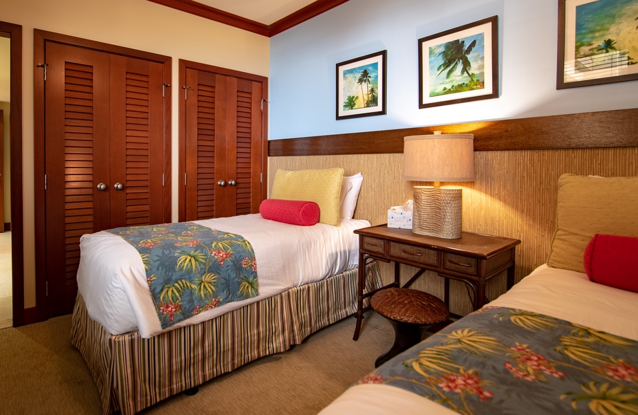 The third guest bedroom featuring colorful prints and twin beds.