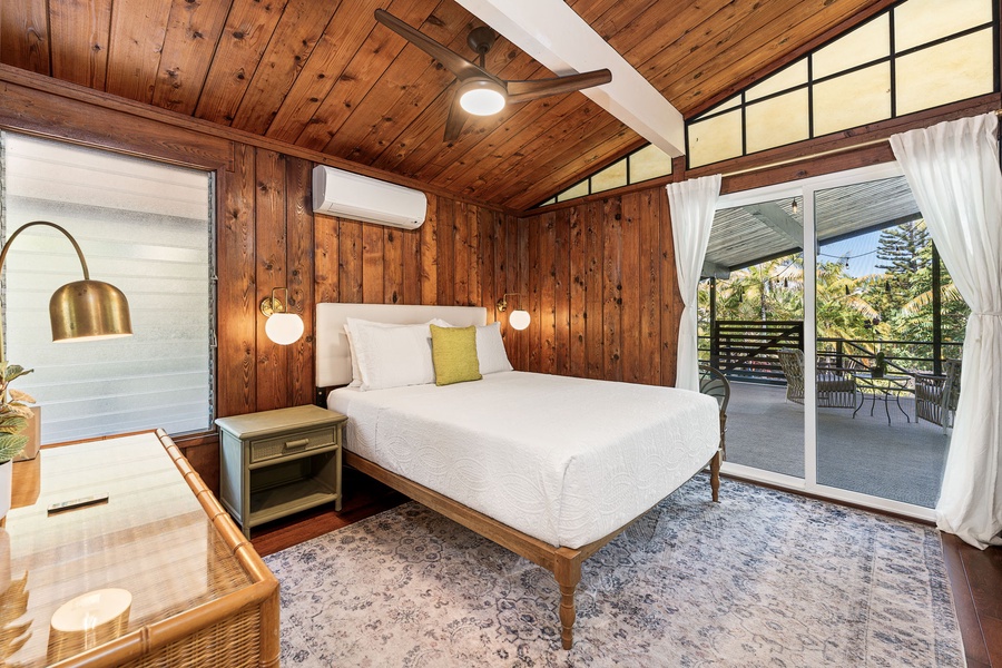 Relax beneath soaring wood ceilings in your private bedroom, where thoughtful decor creates the perfect retreat.