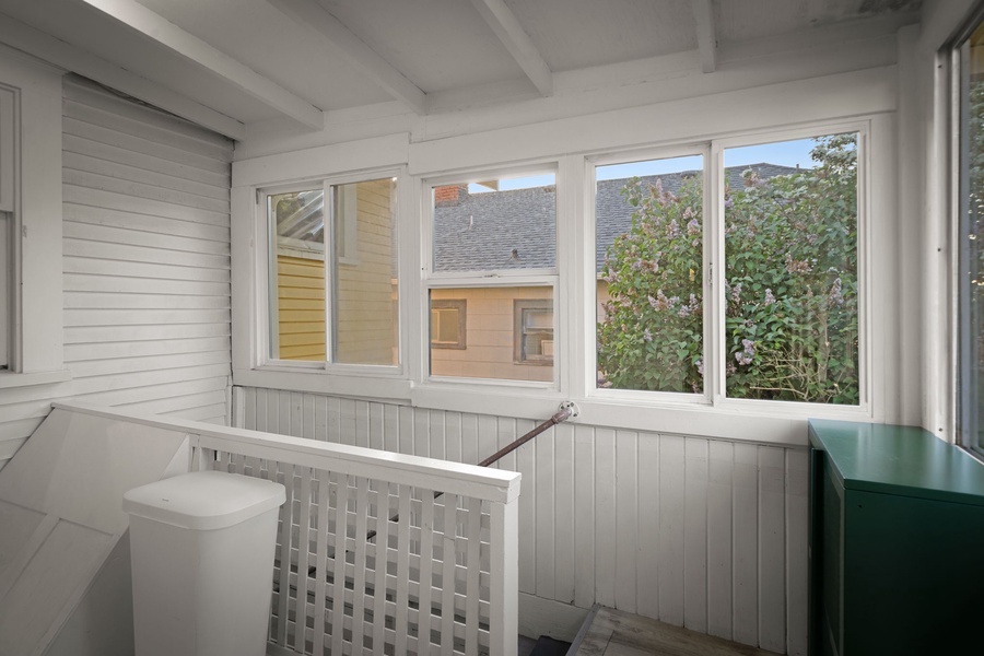 Sip morning coffee in this bright enclosed porch overlooking the York neighborhood.