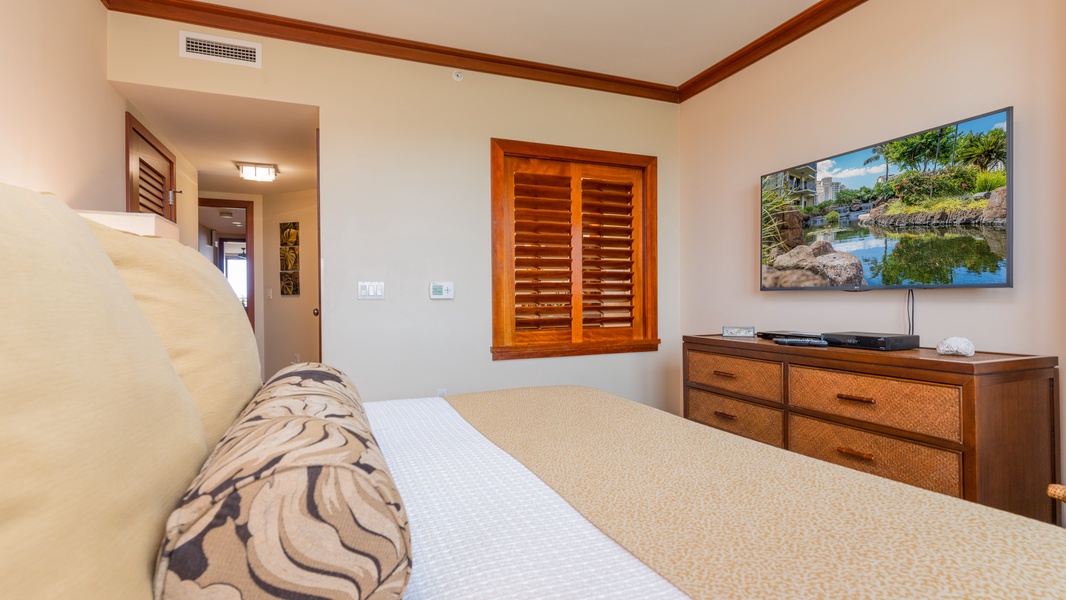 The primary guest bedroom has a bathroom and ceiling fan.