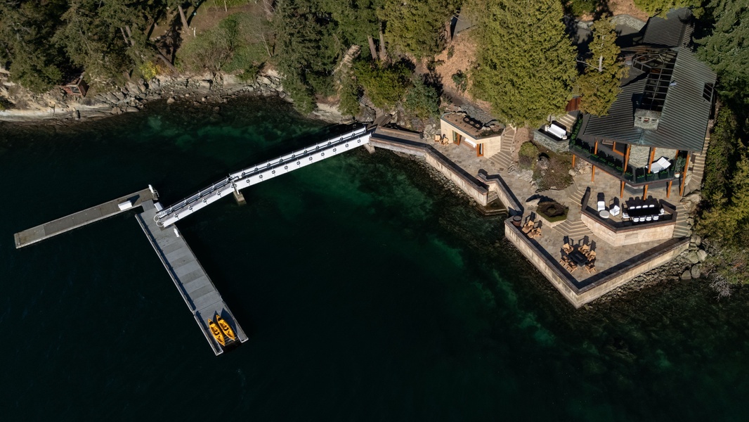 Stunning lakefront property with private dock and kayaks, surrounded by pristine wilderness and crystal-clear waters.