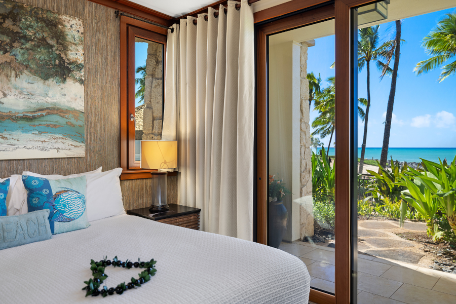 A private lanai off the primary bedroom featuring king bed, and natural light at Ko Olina Beach Villas B109.