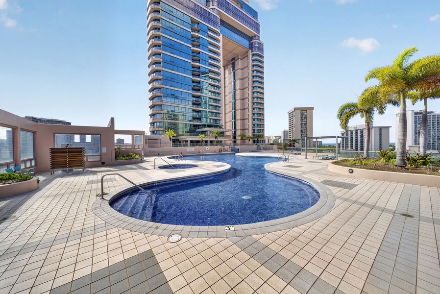 Swim beneath Honolulu’s skyline in the resort-style rooftop pool and spa area.