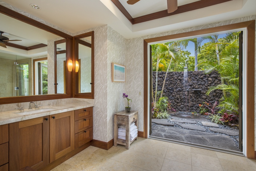 The generous en suite bath opens to the outdoor garden shower