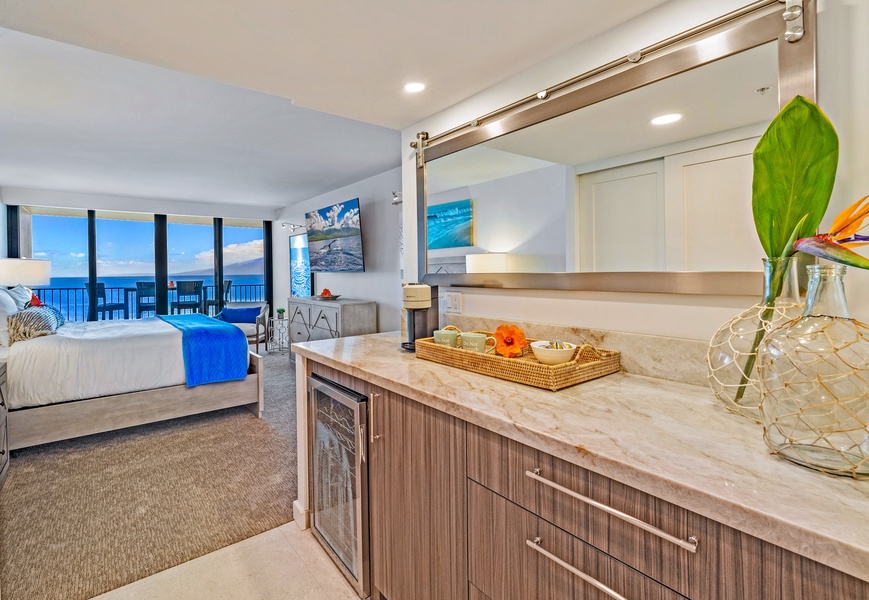 Kaanapali Shores 702's bedroom includes storage and a beverage fridge for easy living.
