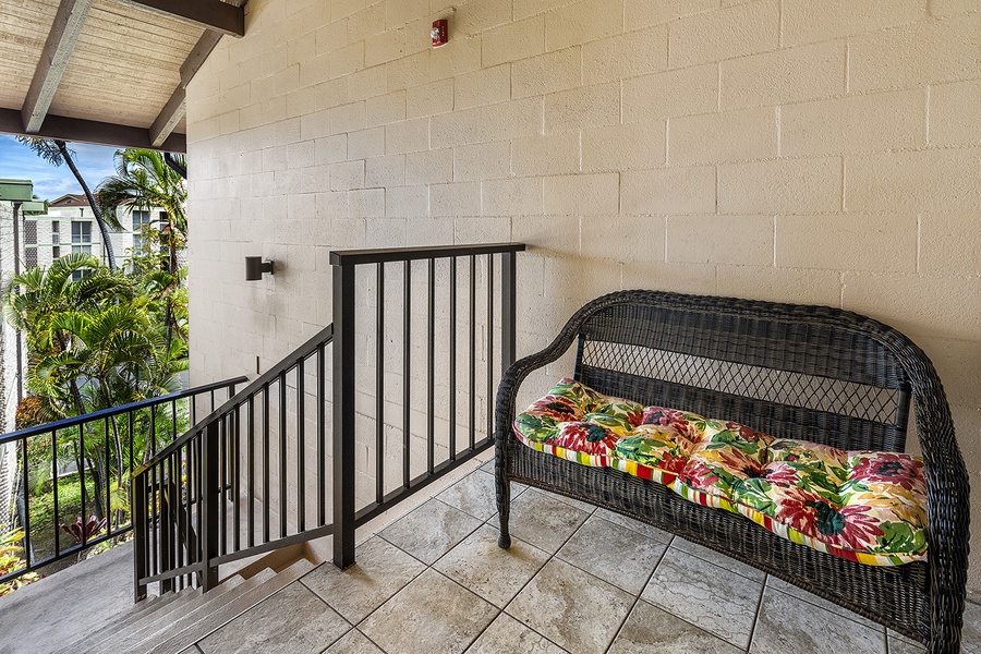 Entry to the condo with a decorative loveseat