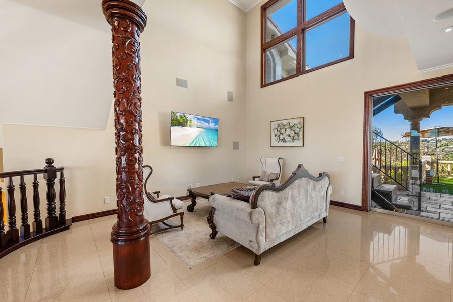 Afternoon light spills past the column into a sitting area you'll keep circling back to.