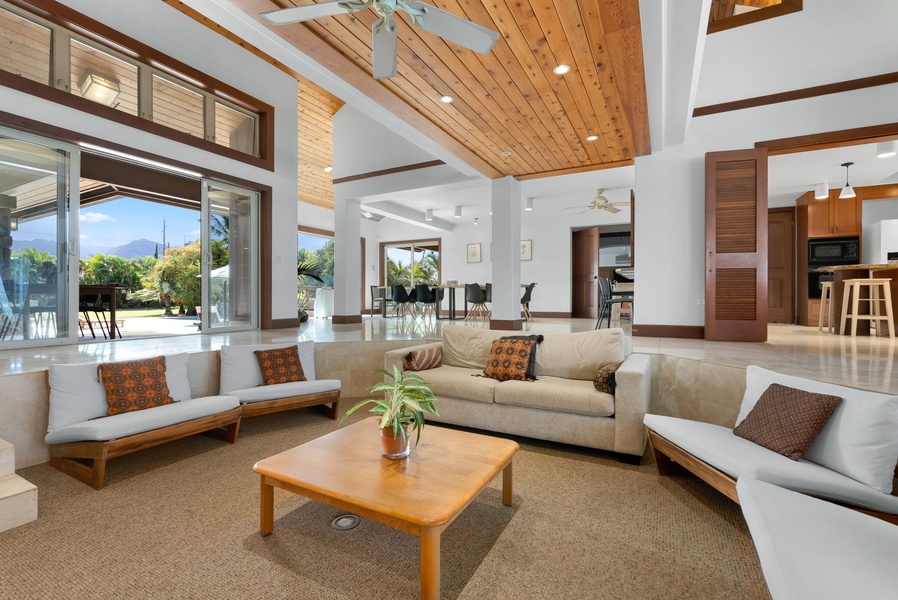 Open-concept living space seamlessly connecting indoors to the tropical outdoors.