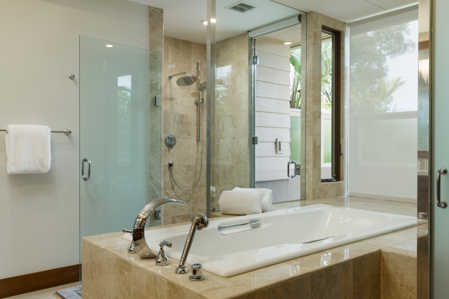 Indulge in the luxurious ensuite bathroom, complete with a spacious soaking tub for ultimate relaxation.