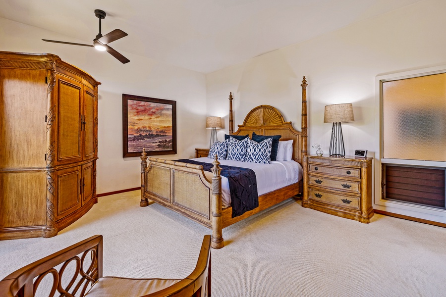 The spacious primary suite offers a cozy king-sized bed, sophisticated decor, and calming artwork