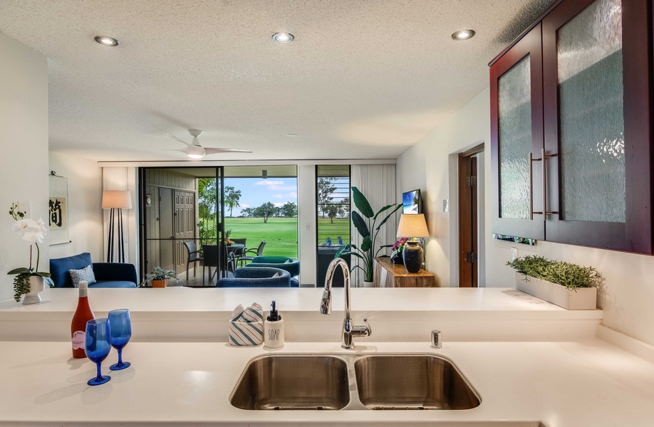 Enjoy panoramic sight lines from the kitchen all the way to the lanai and golf course—truly open-concept island living.