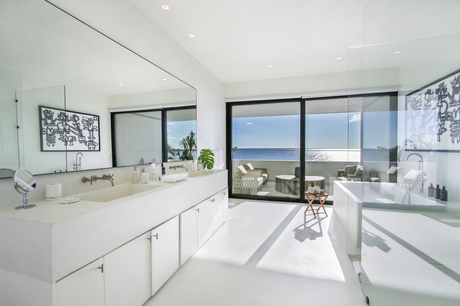 Primary ensuite bathroom with a spacious shower and a beautiful view of the ocean.