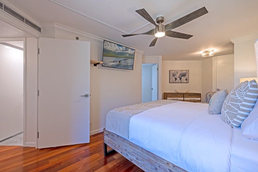 Relax in the king bed at Kaanapali Shores 213, complete with a wall-mounted TV for comfort.