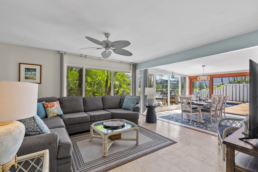 Relax in this inviting living space, where soft tones and tropical artwork create the perfect island retreat ambiance.